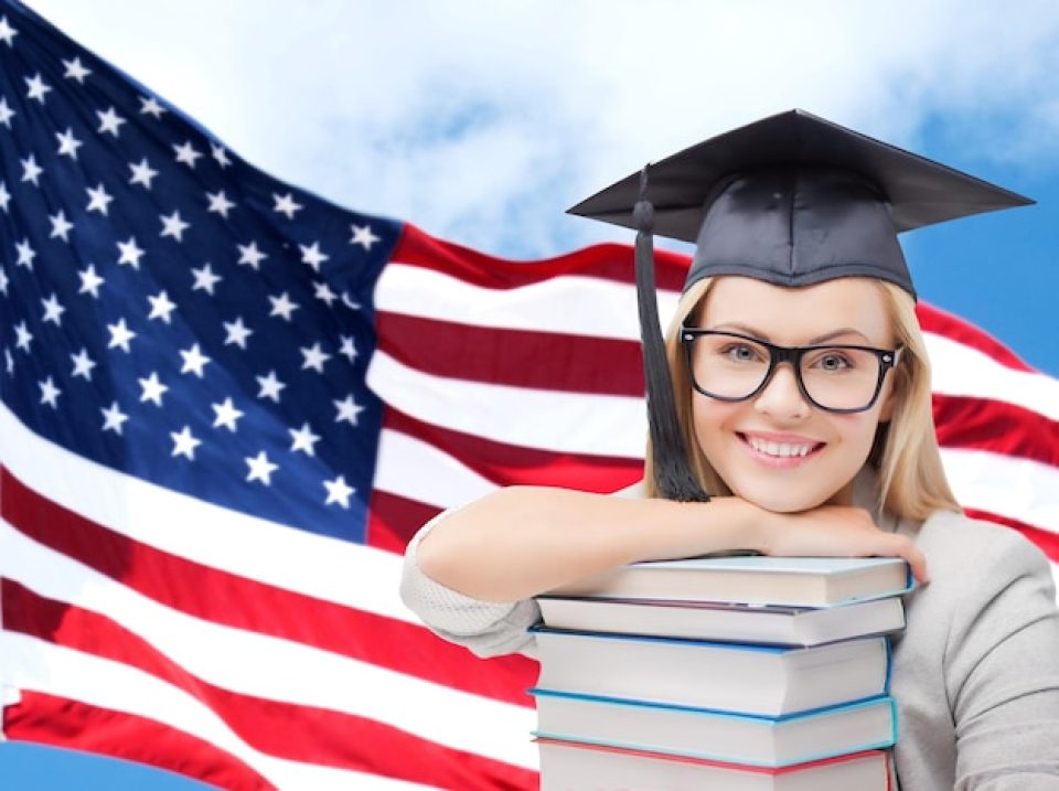fpkdl.com_960_images_fpkdl.com_960_education-high-school-knowledge-people-concept-picture-happy-student-girl-woman-trencher-cap-with-stack-books-american-flag-background_380164-101519